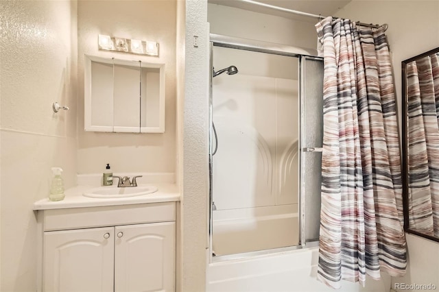 full bathroom with combined bath / shower with glass door and vanity