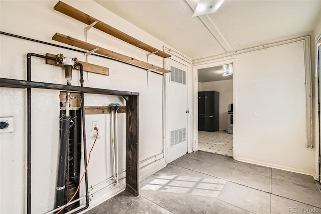 interior space featuring visible vents and freestanding refrigerator