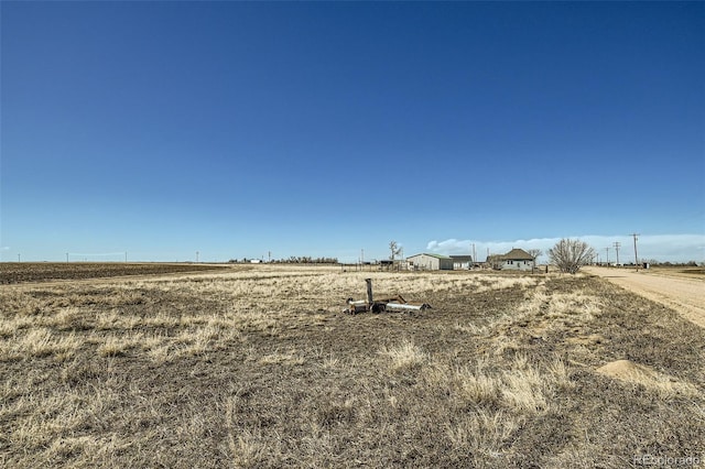 view of yard with a rural view