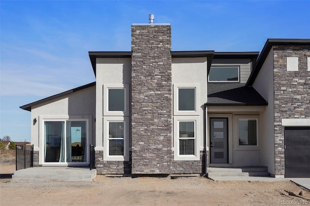 rear view of property featuring stone siding and stucco siding