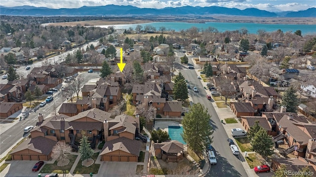 aerial view featuring a water and mountain view and a residential view