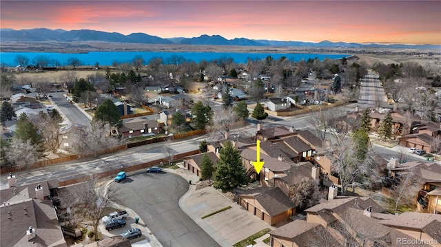 birds eye view of property with a residential view and a water and mountain view