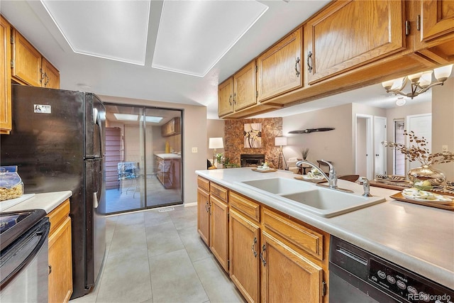 kitchen featuring a sink, electric stove, dishwashing machine, a fireplace, and light tile patterned floors