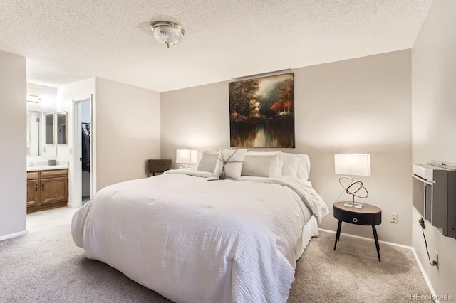 9411 W 89th Cir, Westminster, CO 80021 - bedroom featuring light carpet, baseboards, a textured ceiling, and ensuite bath