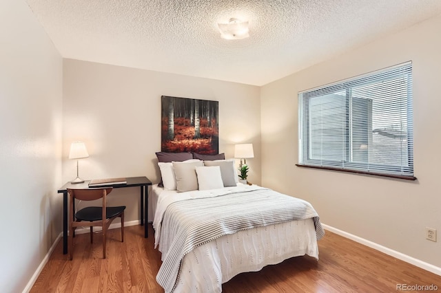 9411 W 89th Cir, Westminster, CO 80021 - bedroom with baseboards, wood finished floors, and a textured ceiling