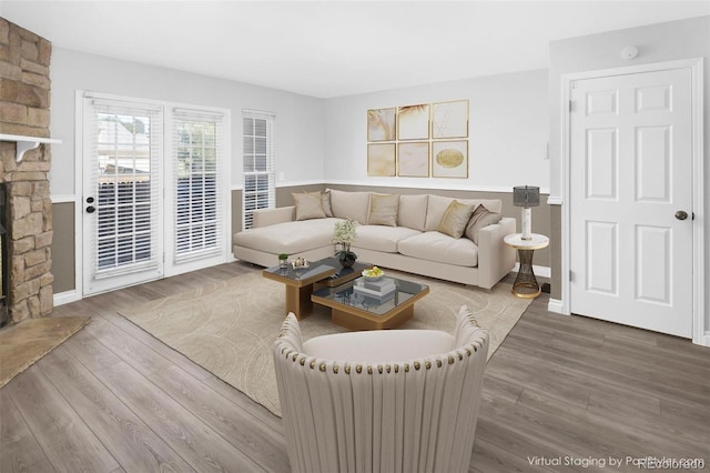 living room featuring a fireplace and wood-type flooring