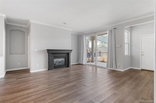 unfurnished living room with wood-type flooring and crown molding