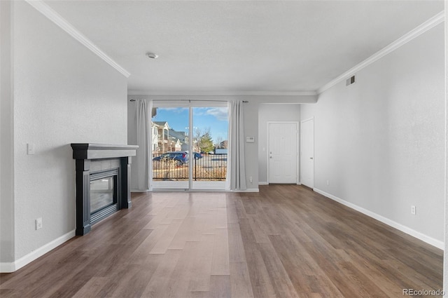 unfurnished living room with wood-type flooring and crown molding