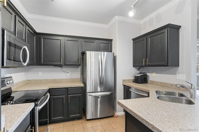 kitchen featuring rail lighting, ornamental molding, stainless steel appliances, sink, and light tile patterned floors