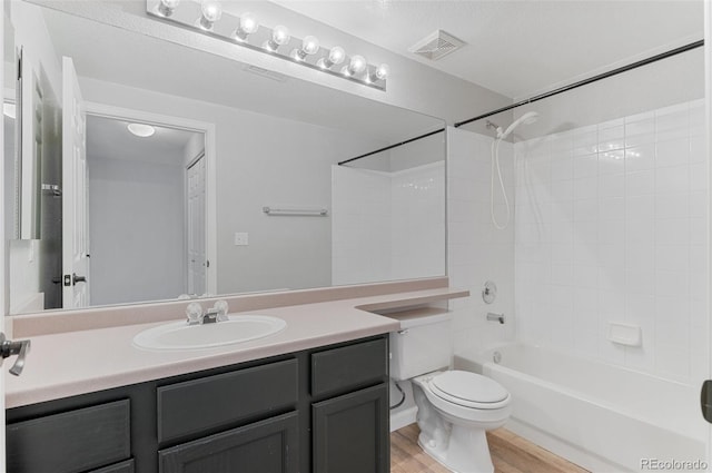 full bathroom with vanity, wood-type flooring, bathtub / shower combination, and toilet