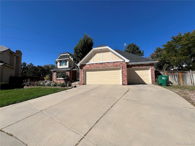 view of front of house featuring a front lawn and a garage