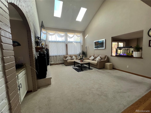 carpeted living room with high vaulted ceiling and plenty of natural light