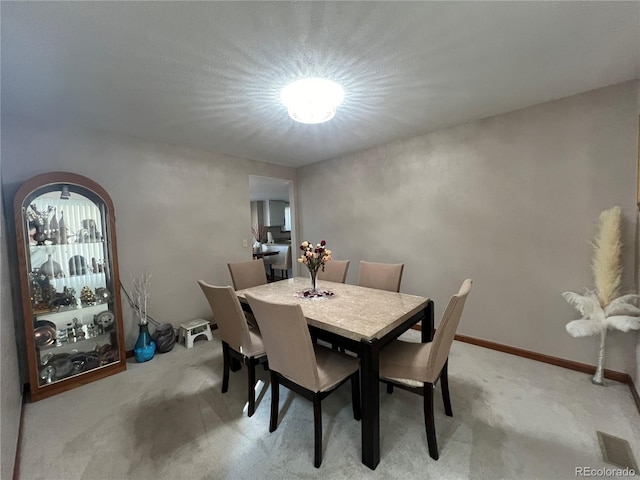 dining room with light carpet