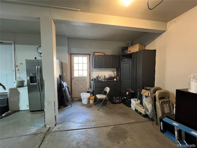 garage with stainless steel refrigerator with ice dispenser