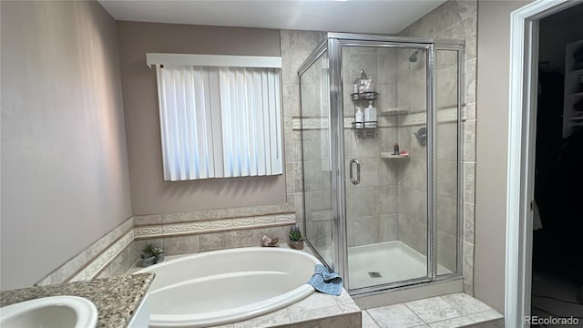 bathroom featuring vanity and separate shower and tub