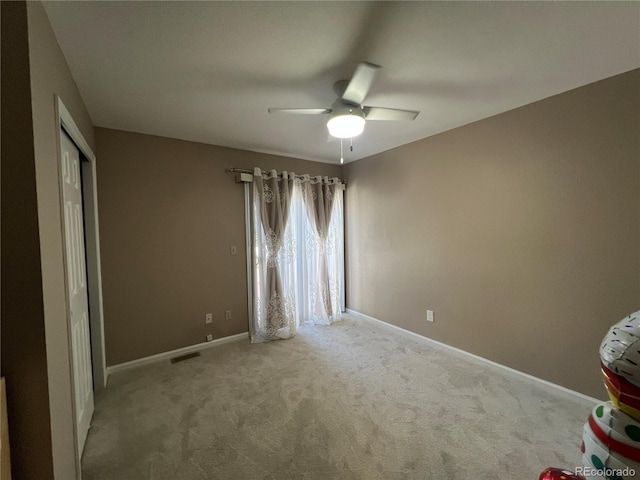 unfurnished bedroom with light carpet and ceiling fan