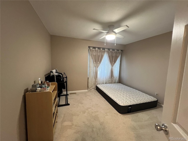 bedroom featuring light carpet and ceiling fan