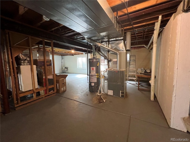 basement featuring gas water heater and heating unit