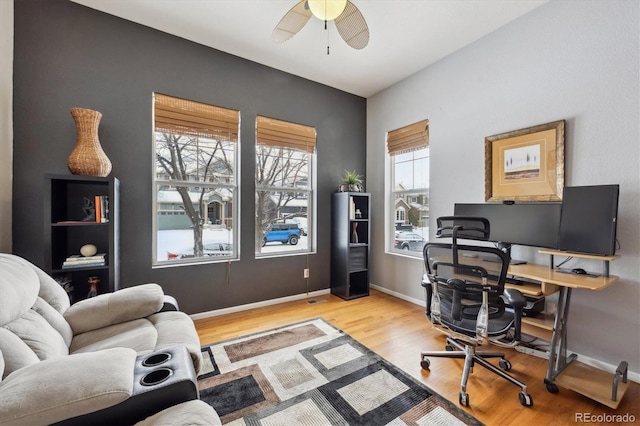 home office featuring light hardwood / wood-style floors and ceiling fan