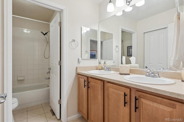 full bathroom featuring vanity, toilet, tiled shower / bath combo, and tile patterned flooring