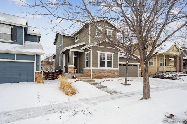 view of front of house with an attached garage and stone siding