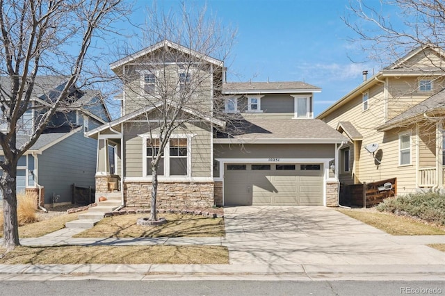 10251 Rifle St, Commerce City, CO 80022 - view of front of property featuring an attached garage, stone siding, and driveway