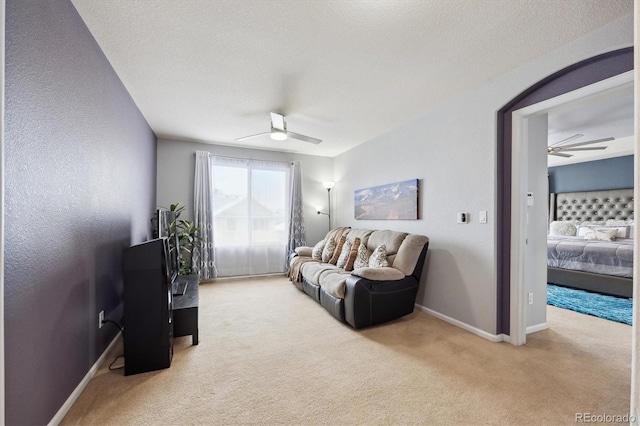 10251 Rifle St, Commerce City, CO 80022 - living room with a textured ceiling, carpet flooring, baseboards, and ceiling fan