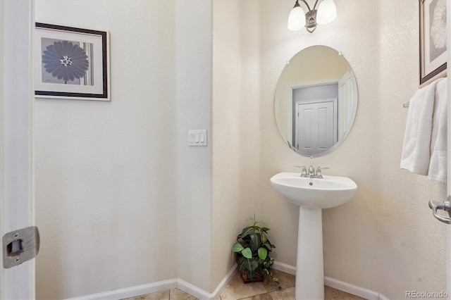 10251 Rifle St, Commerce City, CO 80022 - bathroom with tile patterned floors, baseboards, and a sink