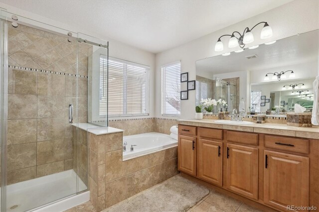 10251 Rifle St, Commerce City, CO 80022 - bathroom with visible vents, a garden tub, a stall shower, tile patterned flooring, and vanity