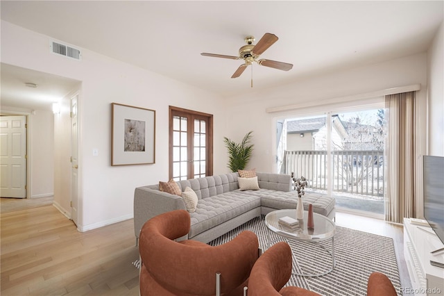 living room featuring ceiling fan, visible vents, baseboards, french doors, and light wood-type flooring