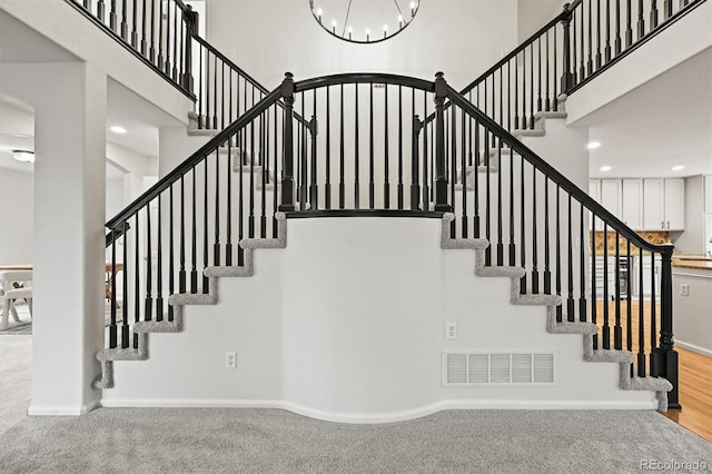 10235 Rustic Redwood Ln, Highlands Ranch, CO 80126 - stairs with a high ceiling, arched walkways, a chandelier, carpet flooring, and baseboards