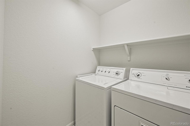 10235 Rustic Redwood Ln, Highlands Ranch, CO 80126 - laundry room featuring washer and clothes dryer and a textured wall