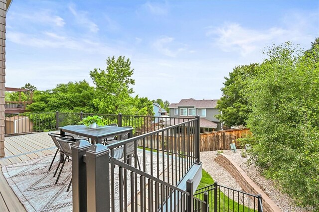 10235 Rustic Redwood Ln, Highlands Ranch, CO 80126 - wooden terrace featuring outdoor dining space and a fenced backyard