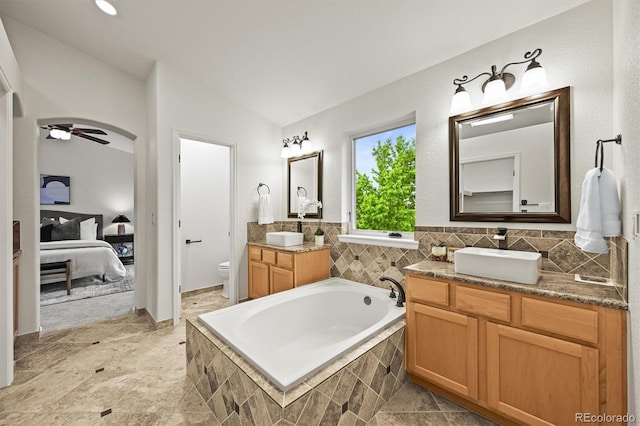 10235 Rustic Redwood Ln, Highlands Ranch, CO 80126 - ensuite bathroom with a bath, toilet, vanity, a ceiling fan, and vaulted ceiling