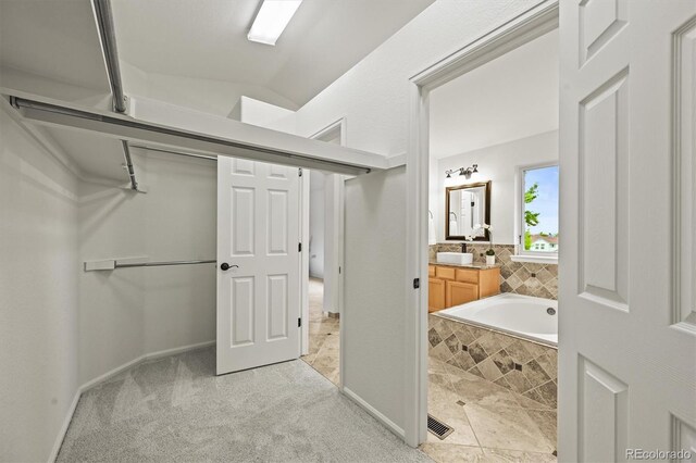 10235 Rustic Redwood Ln, Highlands Ranch, CO 80126 - full bathroom featuring vanity, tiled bath, and baseboards