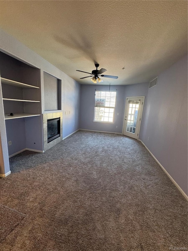 unfurnished living room with a fireplace, baseboards, and dark colored carpet