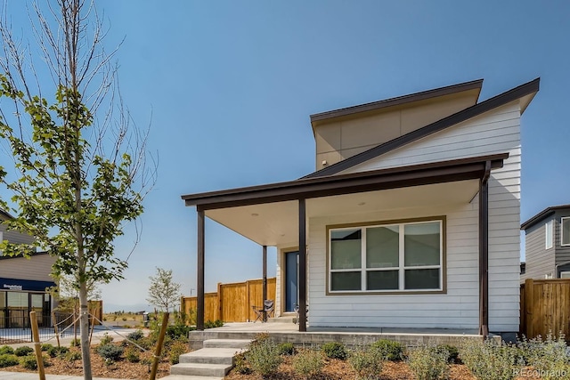 view of front facade with fence and a porch