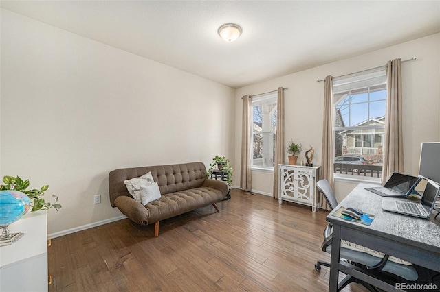 sitting room featuring baseboards and wood-type flooring