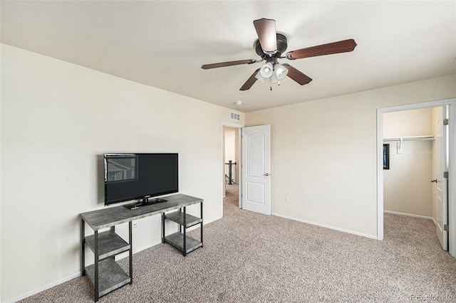 interior space featuring a ceiling fan, baseboards, visible vents, and carpet