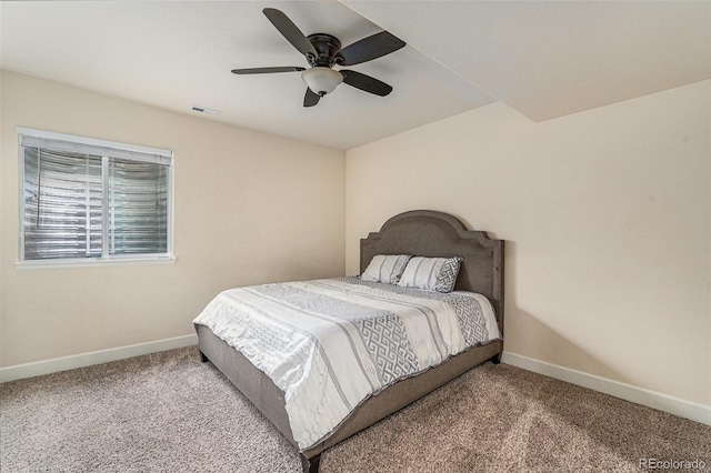 carpeted bedroom with baseboards, a ceiling fan, and visible vents