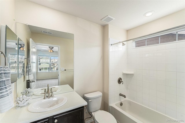 full bath with vanity, toilet, a ceiling fan, tub / shower combination, and visible vents