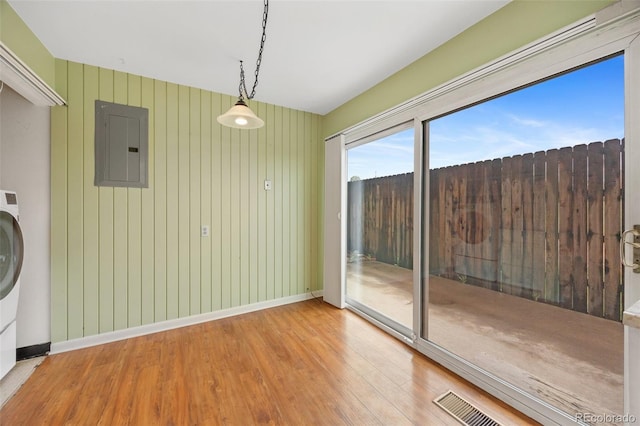 6495 E Happy Canyon Rd Unit 171, Denver, CO 80237 - unfurnished dining area featuring electric panel, wood finished floors, and baseboards