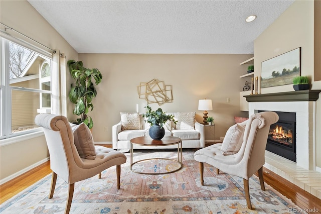 living room with wood-type flooring and a textured ceiling