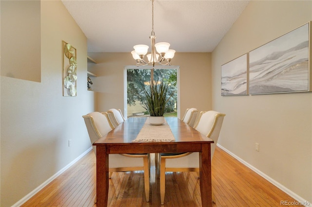 dining space with an inviting chandelier and light hardwood / wood-style floors