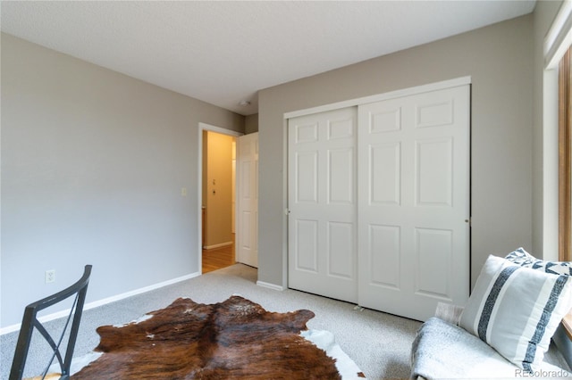 bedroom featuring a closet and light carpet