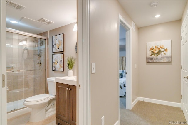 bathroom with a shower with door, toilet, and vanity