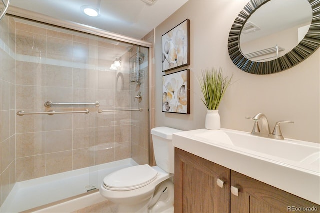 bathroom with vanity, toilet, and walk in shower