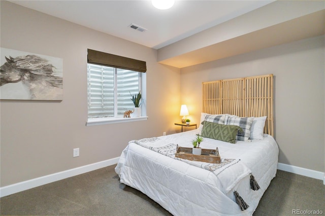 bedroom featuring dark carpet