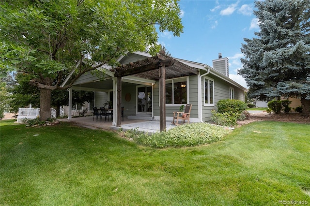 rear view of property with a yard, a patio, and a pergola