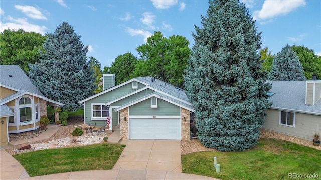 view of front of property featuring a garage and a front lawn